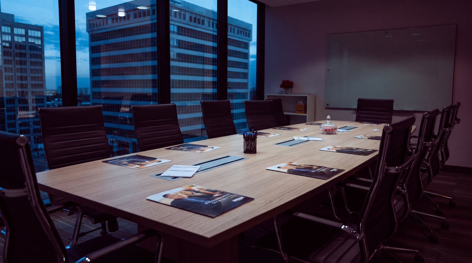 The boardroom table set before a Founder Breakfast, dawn light over the city