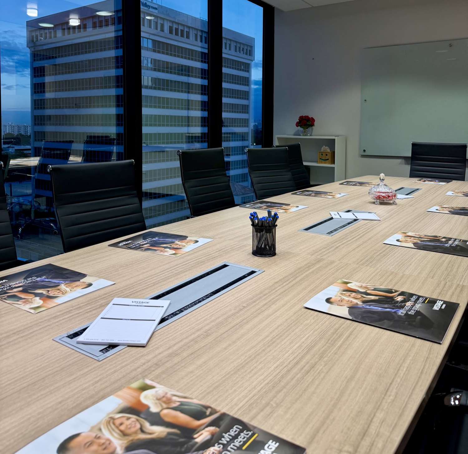 The breakfast table set before the founders arrive, Miami towers outside
